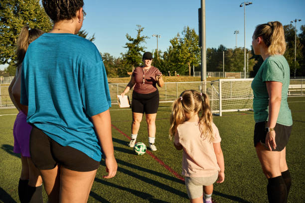istock Coach talking with her soccer players during a team practice outside 1621562103