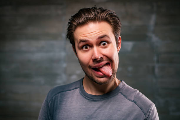 istock Young man showing tongue portrait 1621563743