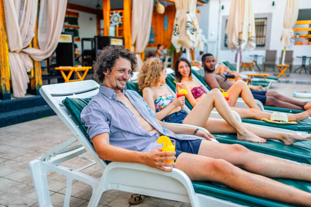 istock Friends relaxing by the pool 1621569614