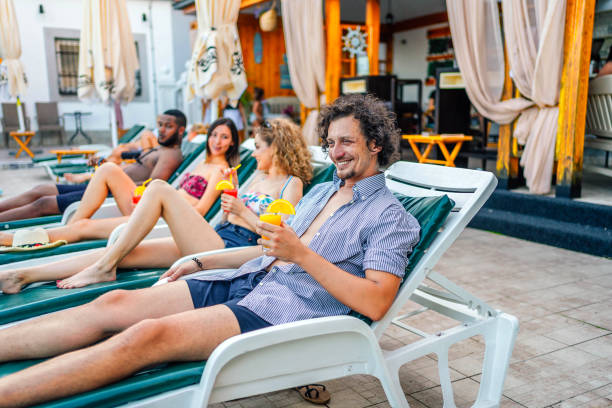 istock Friends relaxing by the pool 1621571545