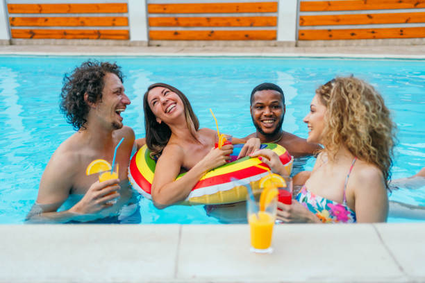 istock Young friends having fun in the swimming pool 1621572244