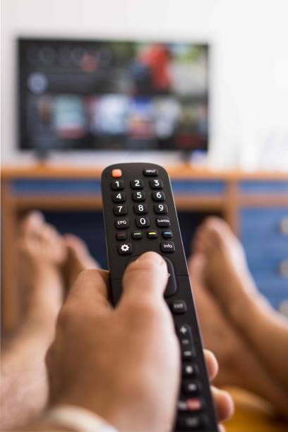 istock Vertical photo of a hand holding a remote control 1621585145