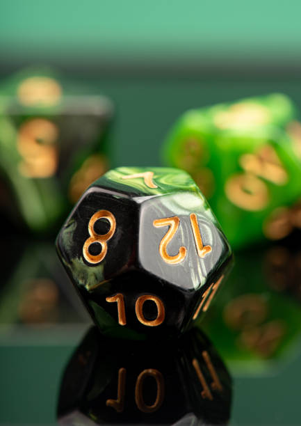 istock RPG dice, beautiful RPG dice placed on reflective surface and dark background, selective focus. 1621589524