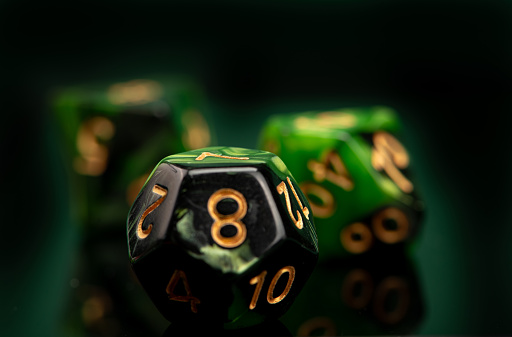 RPG dice, beautiful RPG dice placed on reflective surface and dark background, selective focus.