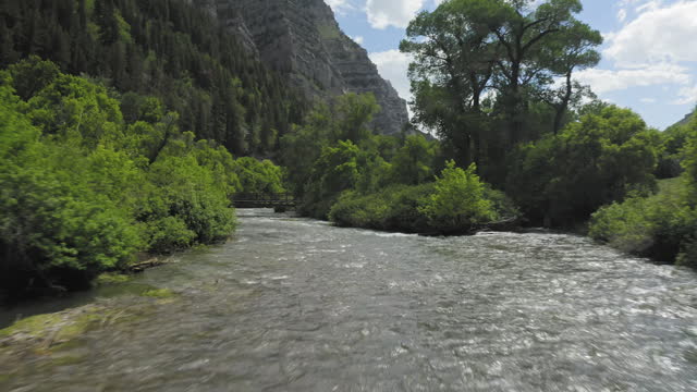 Flying along a flooded and high level Provo River in Spring 2023, drone aerial