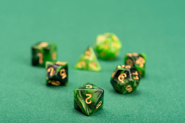 istock RPG dice, beautiful RPG dice placed on green felt surface, selective focus. 1621605603