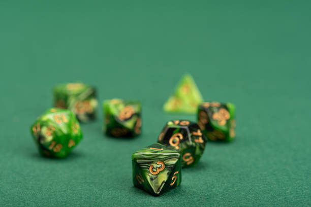 istock RPG dice, beautiful RPG dice placed on green felt surface, selective focus. 1621605604