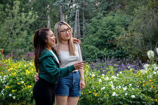 Among the garden's blossoming wonders, two Vietnamese friends stand side by side, sharing a serene moment. With deep breaths and gentle smiles, they take in the view, finding solace and joy amidst the beauty that envelopes them.