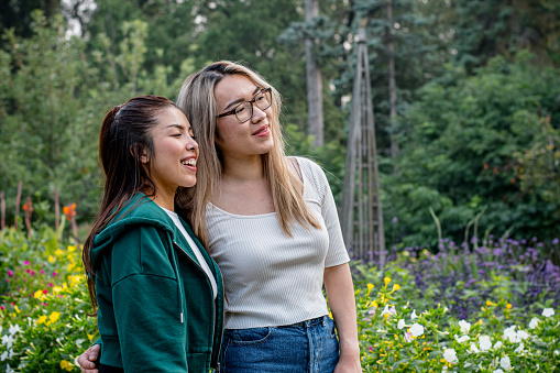 Among the garden's blossoming wonders, two Vietnamese friends stand side by side, sharing a serene moment. With deep breaths and gentle smiles, they take in the view, finding solace and joy amidst the beauty that envelopes them.