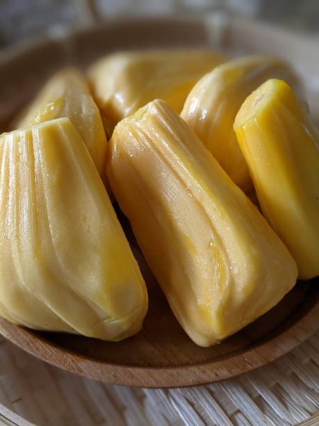 istock Ripe jackfruit peeled tropical fruit fresh from jackfruit tree, jackfruit on white plate with leaf on wooden background 1621707513