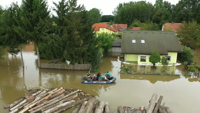 AERIAL Rescuers with Boat Rescuing People from the Flooded Village in Slovenia