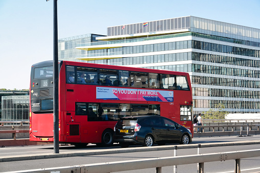 Gorgeous Low Angle view of Bus Service and British Traffic at London Bridge Which is Most Famous and Historical Bridge over River Thames at Central London City of England UK. It Was Clear Sunny Day over London City. Image Captured on June 4th, 2023