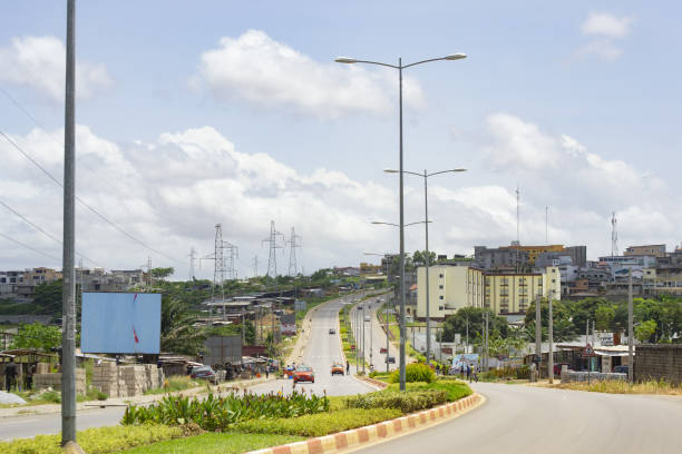 A street in the city of Abidjan in the Ivory Coast A street in the city of Abidjan in the Ivory Coast, more precisely in the Bingerville area, clean spacious roads abidjan skyline stock pictures, royalty-free photos & images