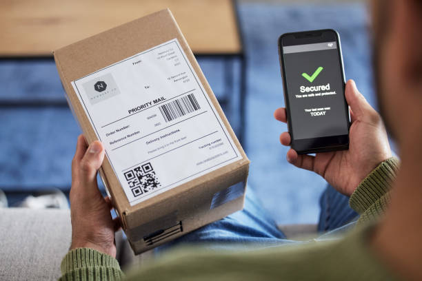 istock Box label, phone screen and person hands reading security verification check, safety scan or track online shopping order. Tick, mail shipping and home customer with cellphone, delivery app or package 1621886480