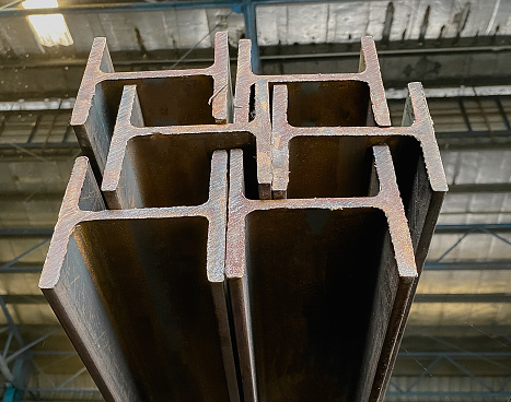 Steel beams production. Metal profile beam Steel in packs at the warehouse of metal products, Products of the metal structure factory, I-beam steel, H-beam welding, Selective Focus, raw materials used in building construction. Steel floor beams in piles. Construction steel, Wi-Frank steel.