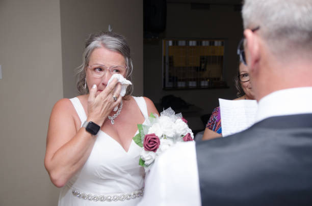 Groom reading wedding vows to bride