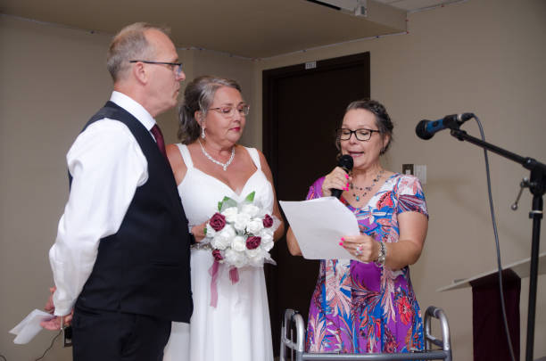 istock Wedding officiant talking to groom and bride 1621962560