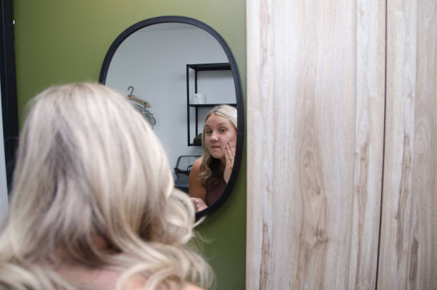 istock Young beautiful woman in front of mirror 1621969904