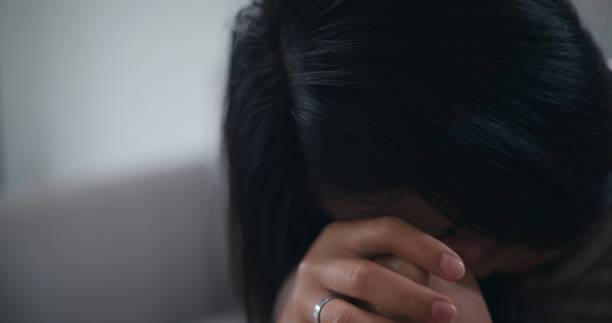 istock Thoughtful pensive sad young female sitting indoors leaning forward propping chin 1621988677