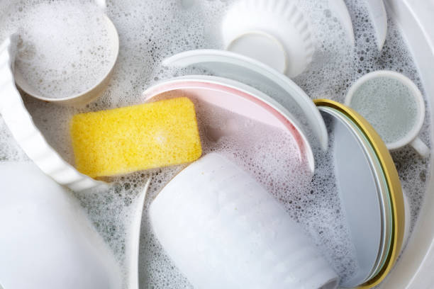 istock Dishes and bowls in water and bubbles of dishwashing liquid. Kitchen work 1621997669