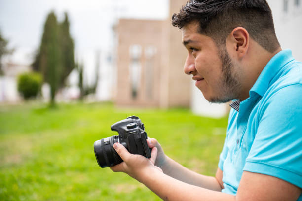 istock Man with autism taking pictures with a camera 1622026336