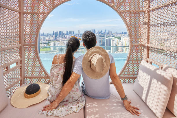 istock Asian couple relaxing in a cabana by hotel pool 1622038321