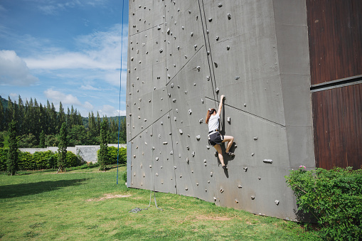 Women activity rock climbing outdoor in tropicla country