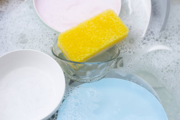 istock Dishes and bowls in water and bubbles of dishwashing liquid. Kitchen work 1622102643