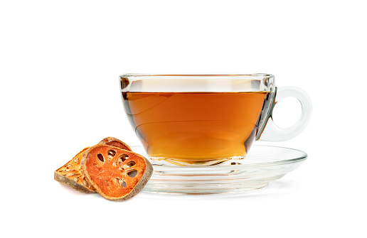 bael fruit tea for healthy beverage with coffee cup isolated on white background ,herbal juice concept