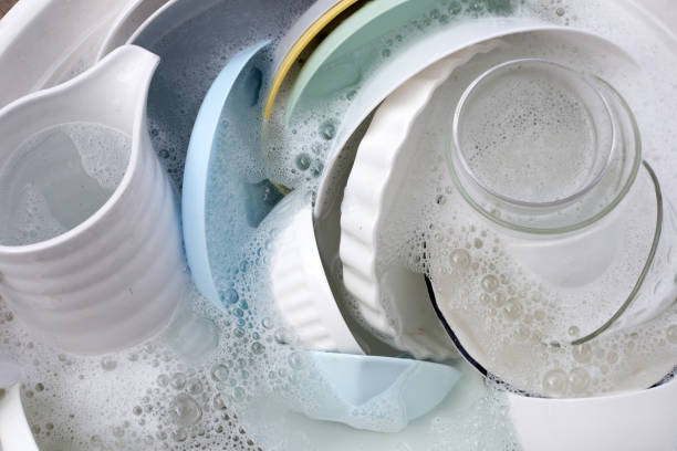 istock Dishes and bowls in water and bubbles of dishwashing liquid. Kitchen work 1622111771
