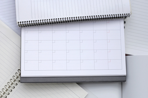 Notebooks with calendar for background. Work planning