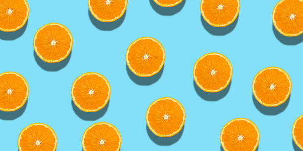 istock Fresh orange halves or slice on a blue background. 1622123951