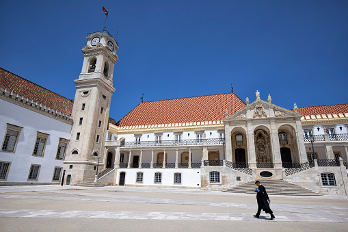 Exterior view of University of Coimbra, Coimbra, Portugal. Students wearing black robes.