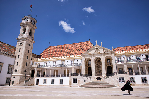 Exterior view of University of Coimbra, Coimbra, Portugal. Students wearing black robes.