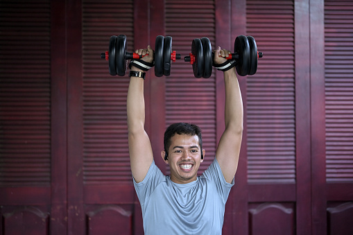 Asian man exercising at home