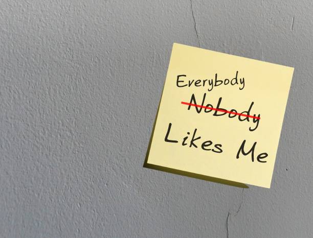 istock Copy space wall with stick note written NOBODY LIKES ME (replace NOBODY with EVERYBODY) - concept of overcome negative self talk and replace with positive affirmation to overcome inner self critic 1622172396
