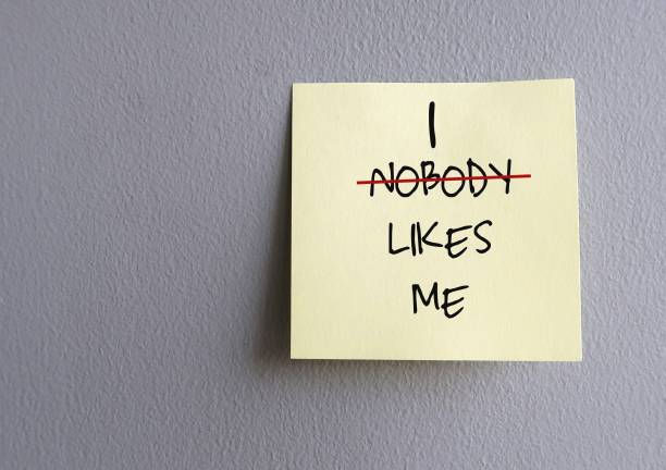 istock Copy space wall with stick note written NOBODY LIKES ME (replace NOBODY with I) - concept of overcome negative self talk and replace with positive affirmation to overcome inner self critic 1622172398