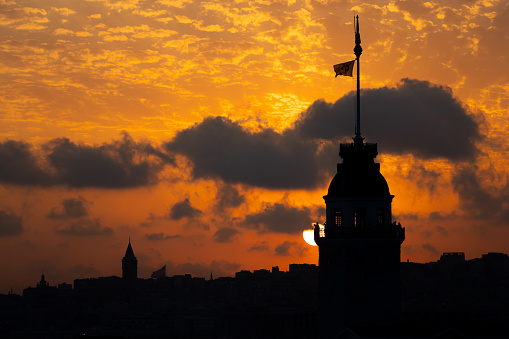 Istanbul cityscape from Üsküdar Coast at orange sunset.