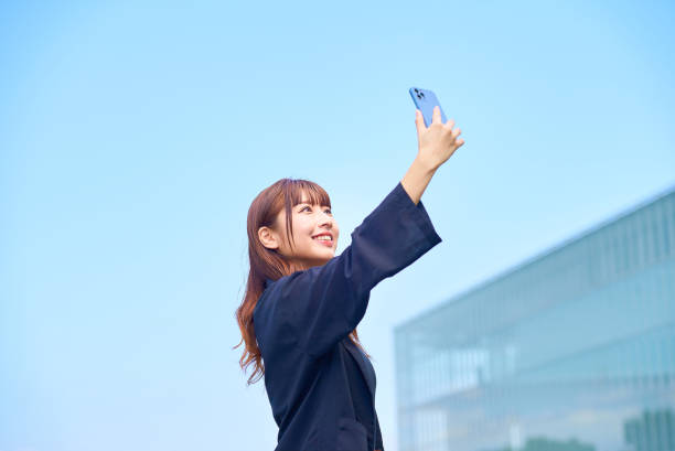 istock young woman holding a smartphone 1622178167