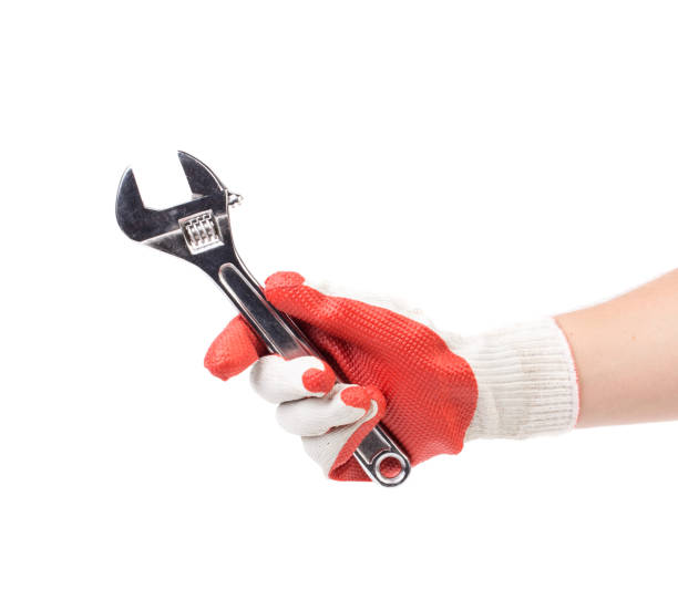 istock A gloved hand holds an adjustable wrench. 1622179768