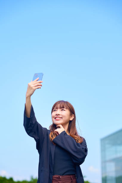 istock young woman holding a smartphone 1622180808