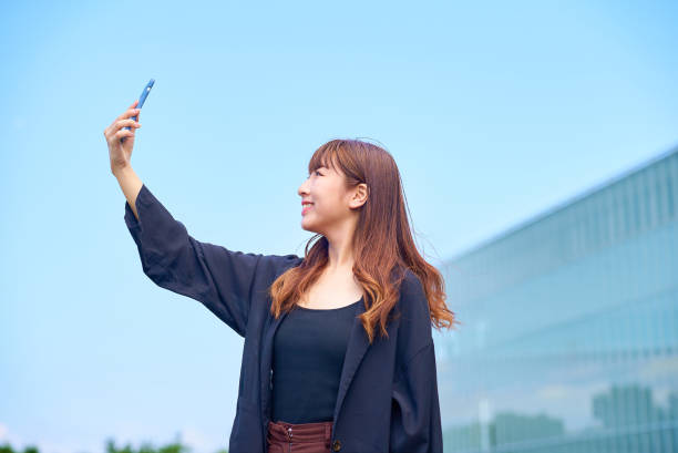 istock young woman holding a smartphone 1622181320