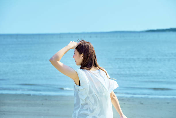 istock woman walking on the beach 1622182893