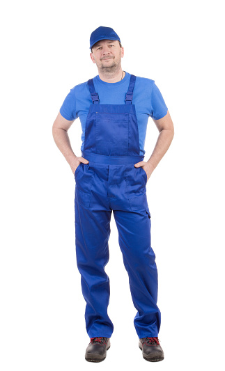 A worker in a blue bib overalls. Isolated on a white background. Close-up.