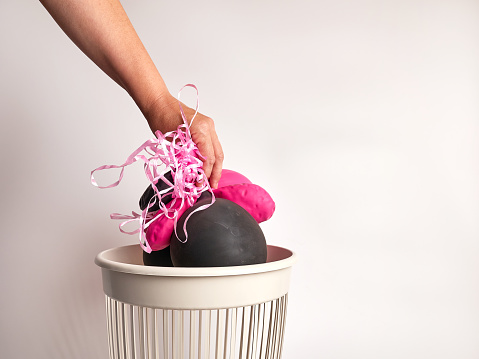 Deflated balloons are thrown into the trash for disposal and recycling