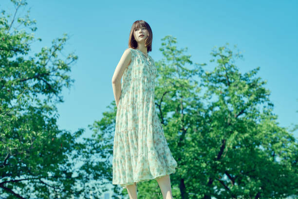 Young woman walking in a green space