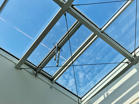 shading of the glazed ceiling of the atrium of the building. blinds under the skylight protect the interior from overheating in the sun. automatic download to the side. roof windows in hall, gallery