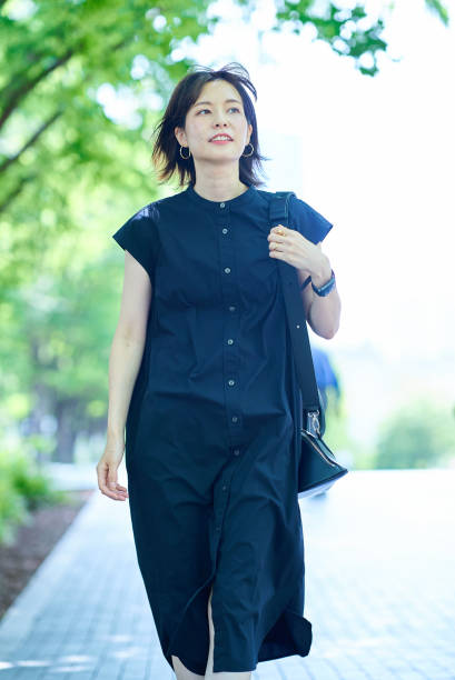 istock Young woman walking along a tree-lined street 1622264193