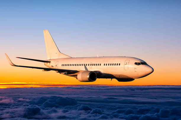 istock White passenger airplane is flying in the sunrise sky 1622291896