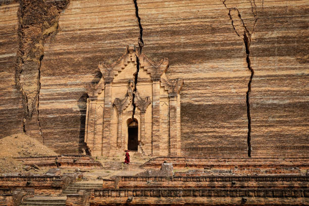 A Buddhist monk coming to Pahtodawgyi in Mandalay, Myanmar. Pahtodawgyi is an incomplete monument stupa in Mingun, approximately 10 km northwest of Mandalay.